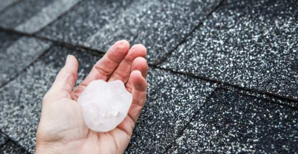 inspecting roof after a hail storm