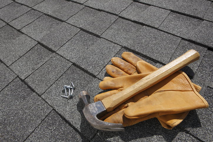 roof with hammer, nails and gloves